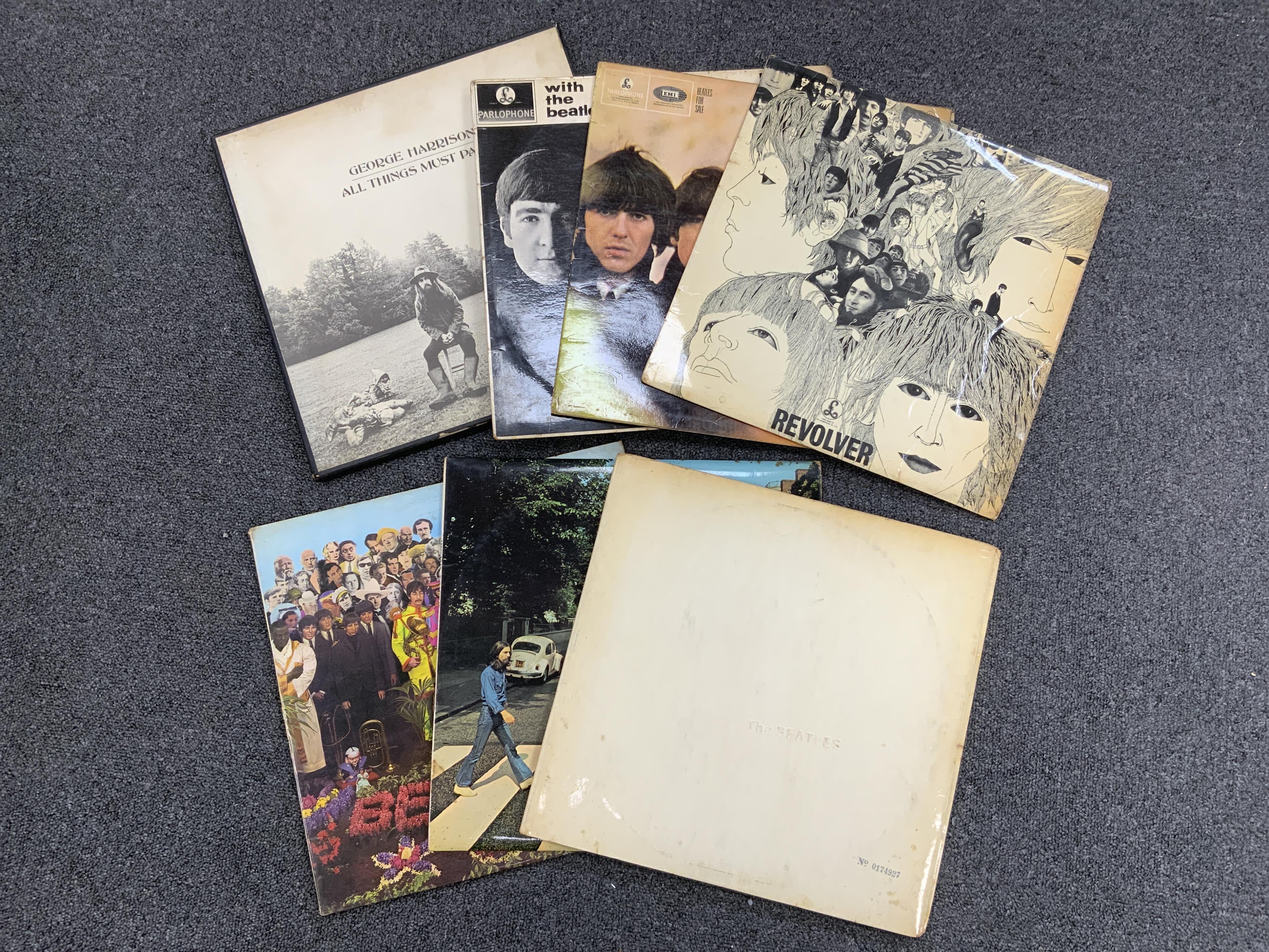 Seven The Beatles and George Harrison LP record albums; the ‘White Album’ (No.0174927), Abbey Road, PCS 7088, Sgt. Pepper, PMC 7027 (missing card insert), Revolver, PMC 7009, Beatles For Sale, PMC 1240, With The Beatles,